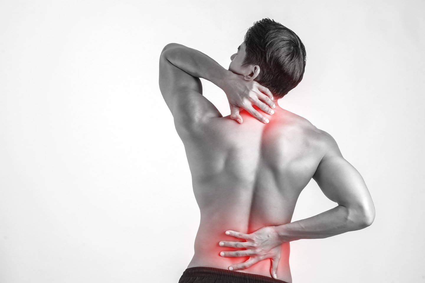 Close up of man rubbing his painful back isolated on white backg